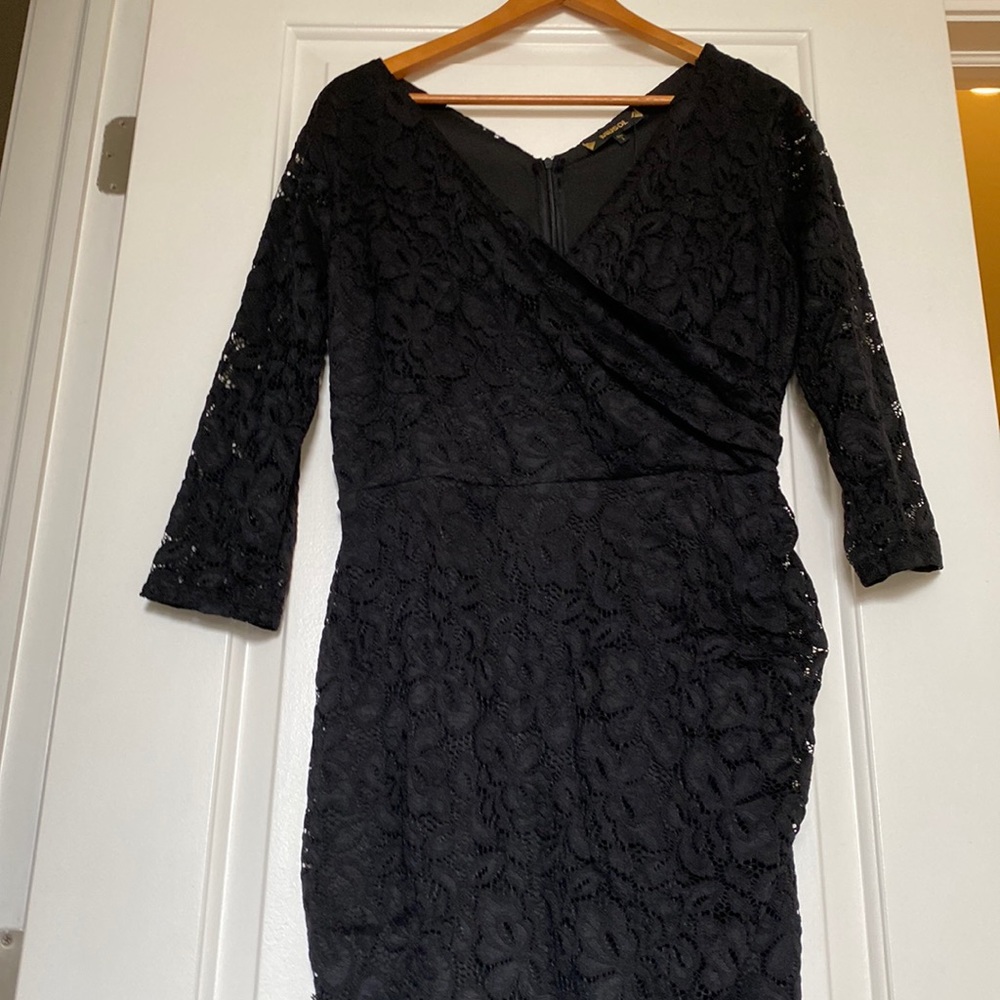 Brand new Black low plunged laced dress.